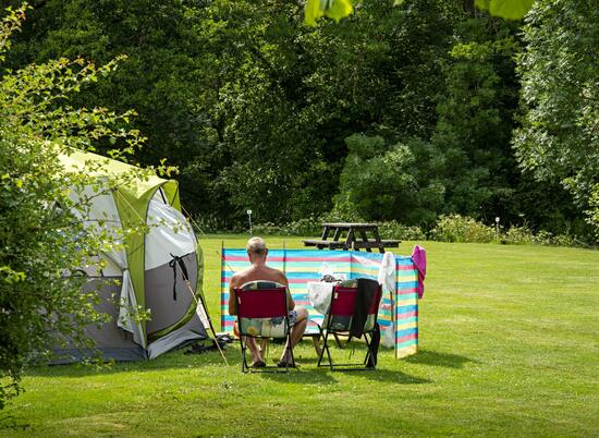 Relaxing grass camping field at Rockbridge Park, Wales