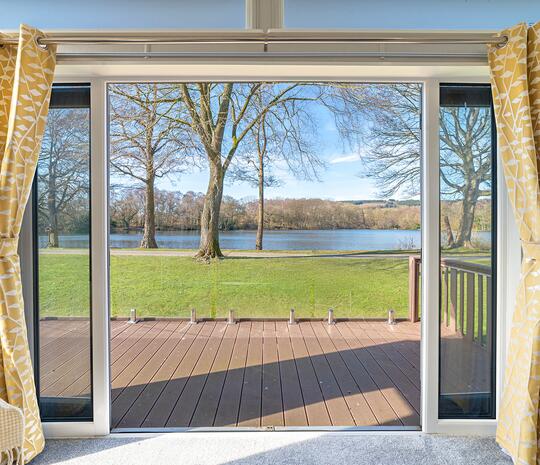Willerby Vogue Nouveau for sale on lake edge pitch at 5 star caravan holiday park. Pitch view photo