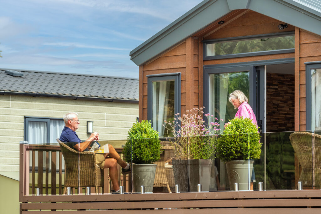 Relaxing on the decking at Pearl Lake Country Holiday Park, Herefordshire