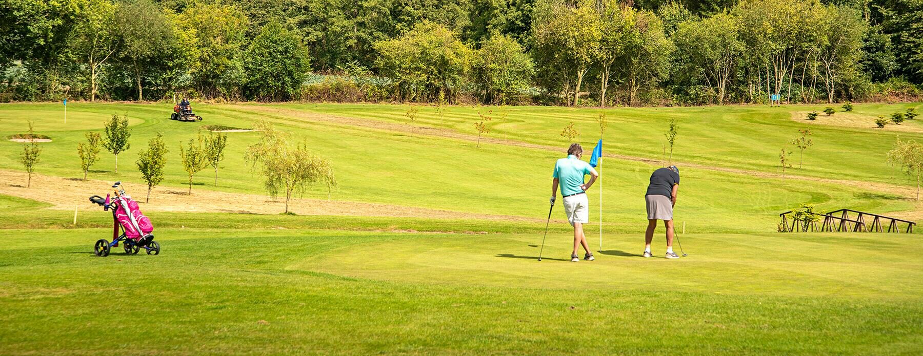 Guest Playing Golf - Discover Parks