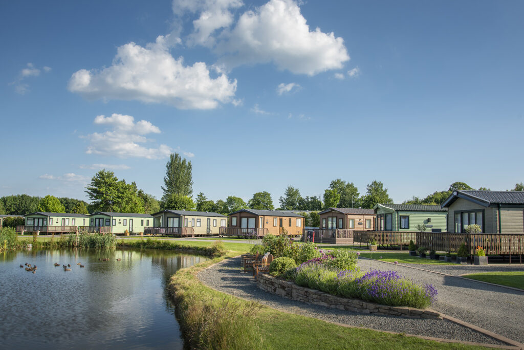 Lake edge holiday homes at Arrow Bank Country Holiday Park