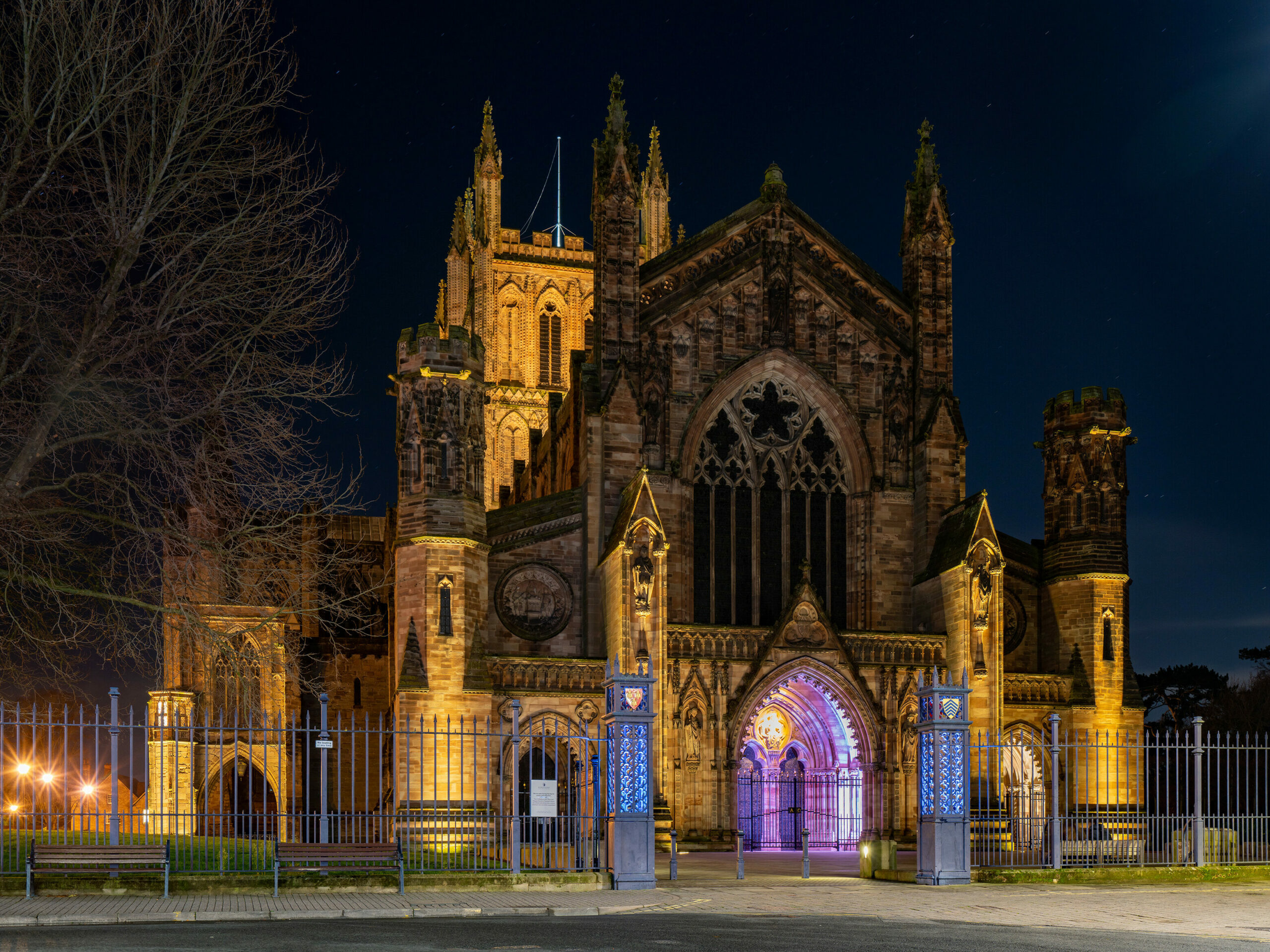 Hereford Cathedral illuminated at night, venue for the Christmas Music by Candlelight concert.