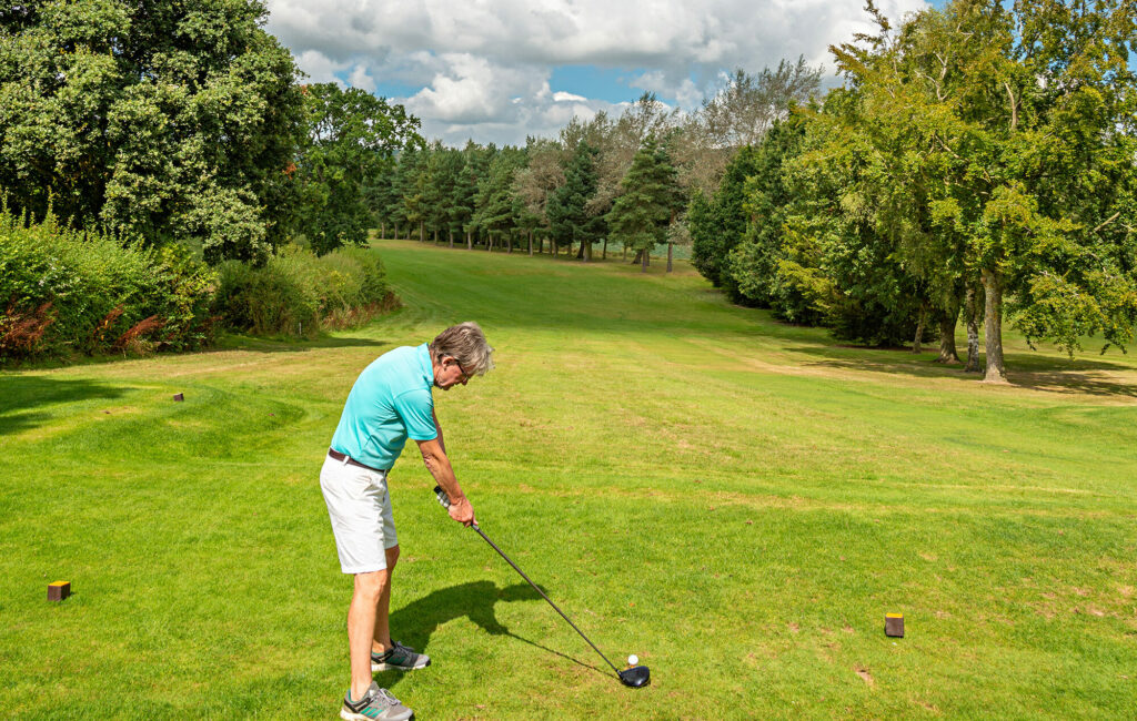 Golfer practicing swings with club hire equipment on the Pearl Lake course.