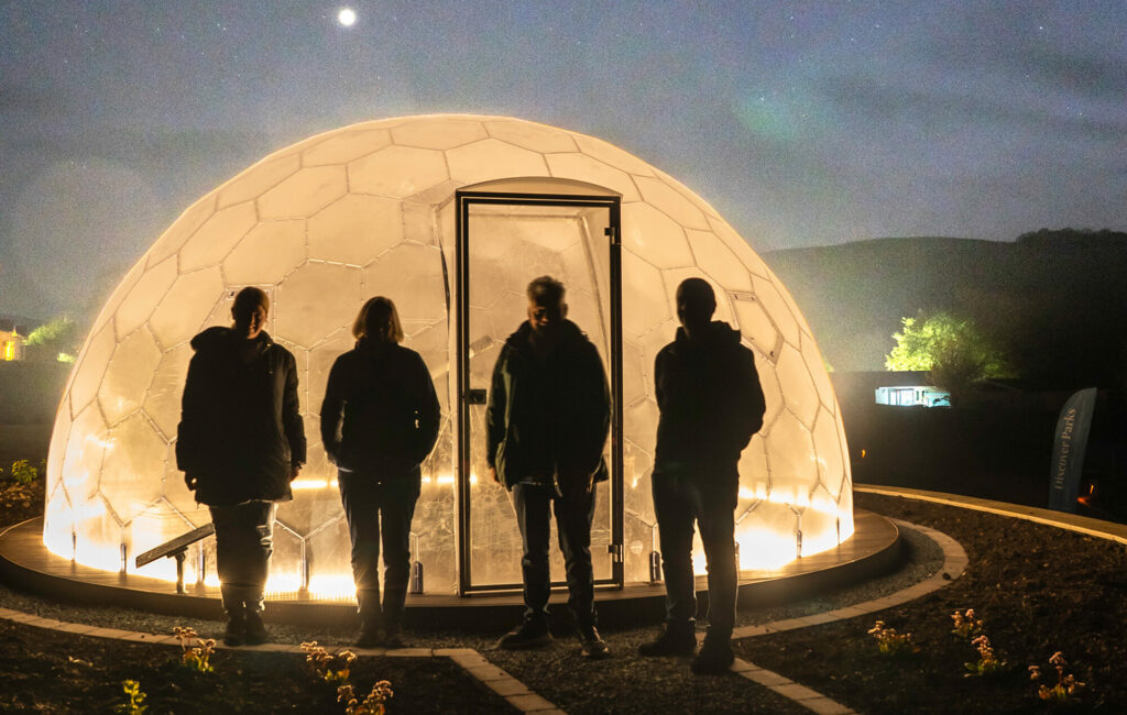 4 holidaymakers outside the stargazing dome at Rockbridge Country Holiday Park