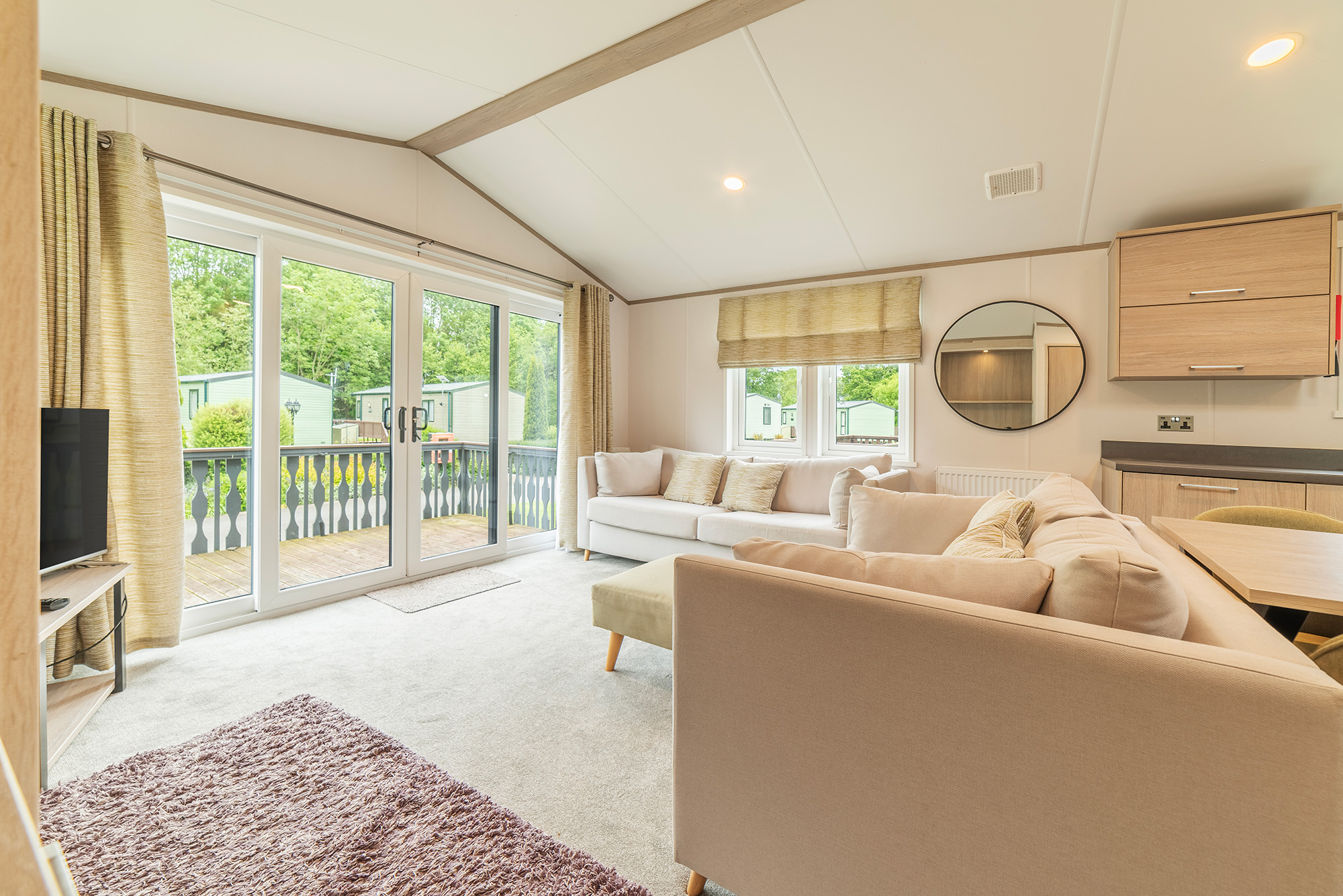 Atlas Jasmine Lodge caravan holiday home for sale at Arrow Bank Country Holiday Park, Herefordshire. Lounge and patio doors photo