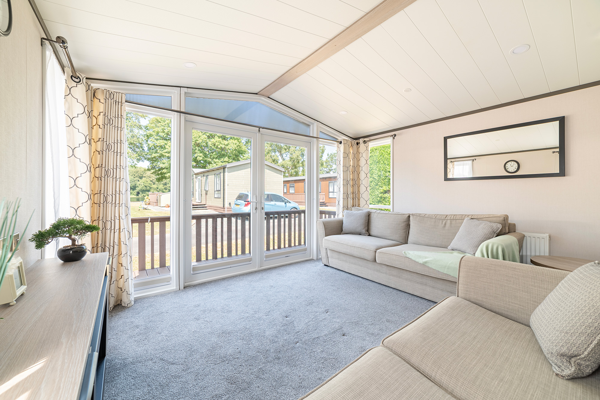 Lakewood Lodge holiday home for sale at Pearl Lake Country Holiday Park - Lounge and patio doors photo
