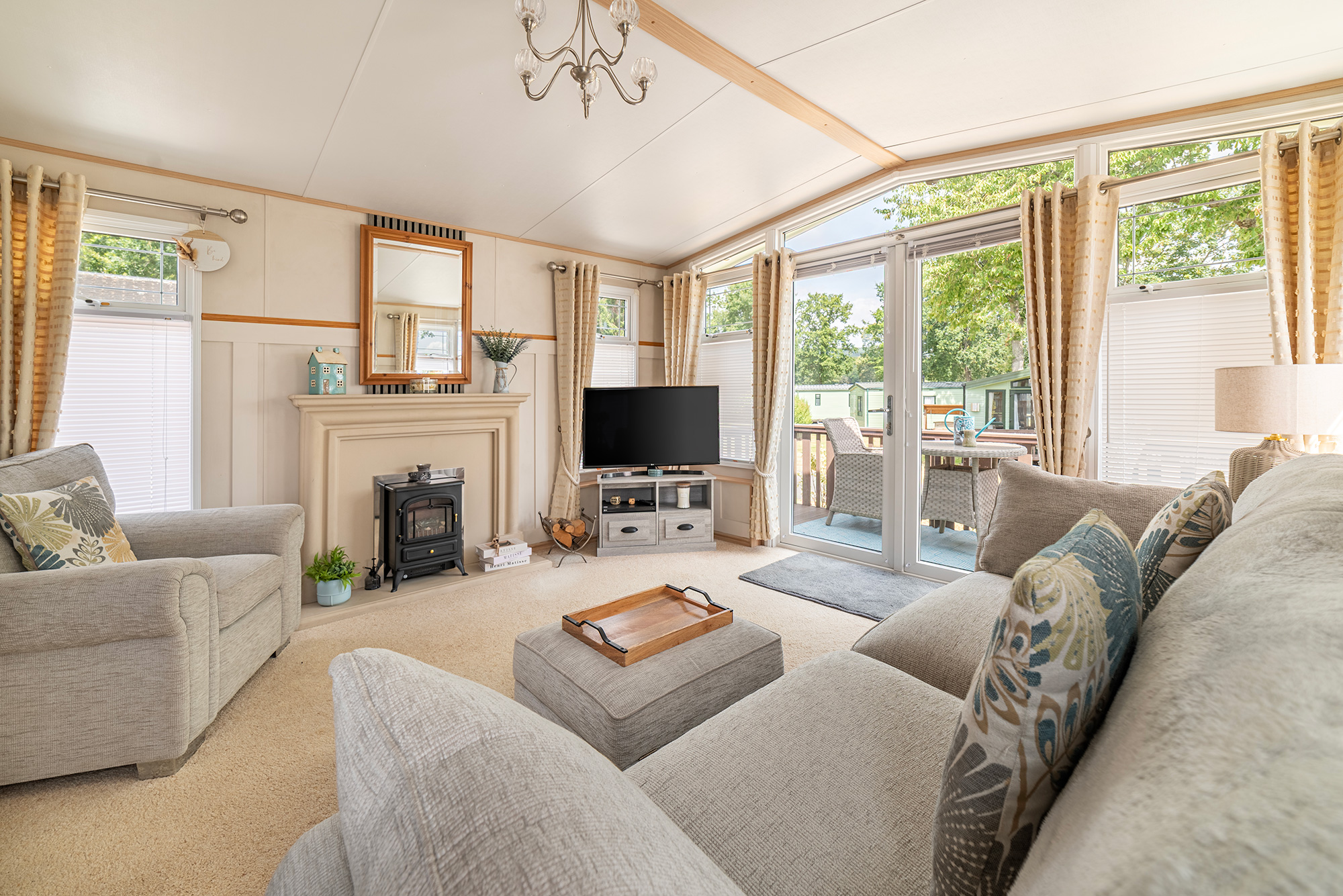 ABI Westwood holiday home for sale at Pearl Lake Country Holiday Park - lounge showing fireplace and patio doors photo